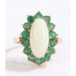 9 carat gold white opal and green stone ring, the head set with a large oval claw mounted white opal