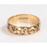 9 carat gold wedding band, the band decorated with a etched effect, ring size K weight 1.9 grams