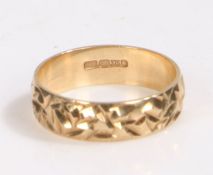 9 carat gold wedding band, the band decorated with a etched effect, ring size K weight 1.9 grams