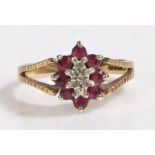 9 carat gold garnet and diamond ring, the head set with a illusion set diamond surrounded by eight