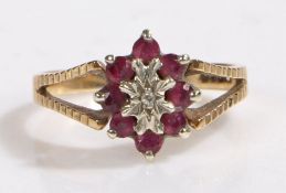 9 carat gold garnet and diamond ring, the head set with a illusion set diamond surrounded by eight
