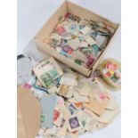 Collection of used loose world stamps, housed in a small box and envelope