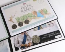 Two Westminster coin covers, The Naming of Queen Elizabeth Land 2013, Peter Rabbit stamp and coin