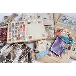 Collection of early 20th century postcards, two stamp albums with part contents, an edition of Arms,