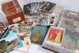 Two albums of postcards, some early 20th century examples, mostly coloured, a box of modern