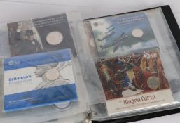 Album containing coin and stamp covers, to include the Magna Carta £2 coin, 75th Anniversary of