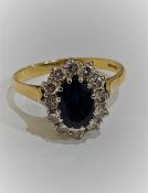 18 CARAT GOLD SAPPHIRE AND DIAMOND CLUSTER RING