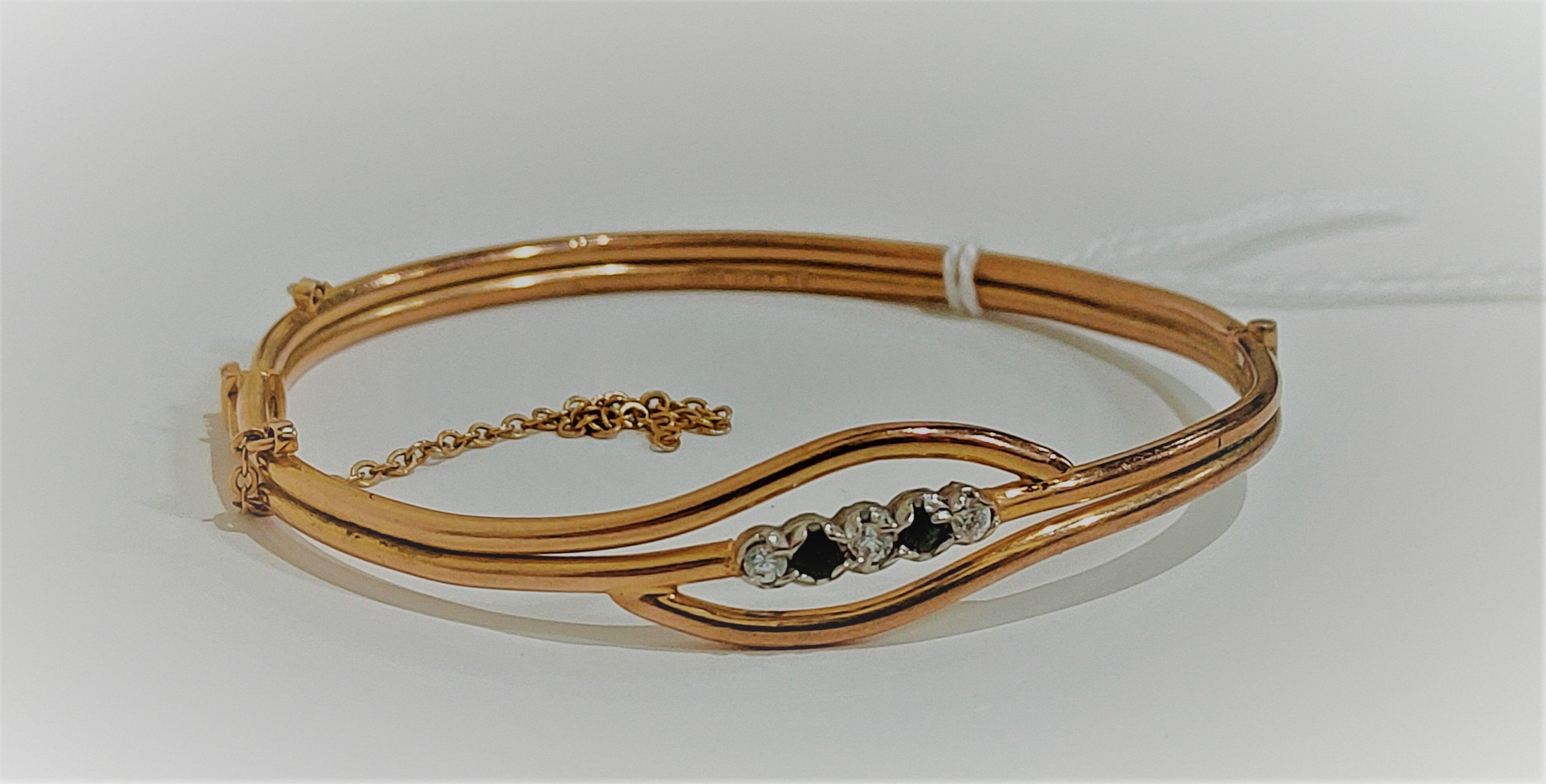 18 CARAT ROLLED GOLD BLUE AND WHITE SAPPHIRE BANGLE