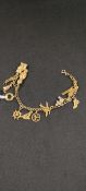 9 CARAT GOLD CHARM BRACELET WITH 12 GOLD CHARMS