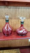 2 ANTIQUE RUBY GLASS DECANTERS WITH SILVER COLLARS
