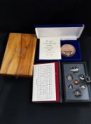 2 COIN SETS AND WOODEN BOX