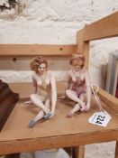 PAIR OF EROTICA PORCELAIN FEMALE FIGURES ON BLACK POLISHED BASES