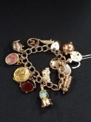 9 CARAT GOLD CHARM BRACELET POSSIBLY SOME HIGH CARAT CHARMS 60.55G