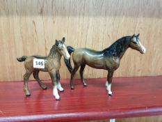 BESWICK MODEL OF A SWISHTAIL HORSE AND BESWICK MODEL OF A SHIRE FOAL