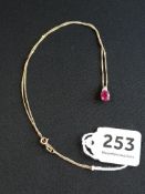 9 CARAT GOLD RUBY AND DIAMOND DROP ON 9 CARAT GOLD CHAIN