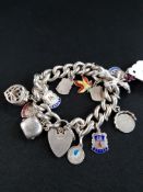 HEAVY SILVER CHARM BRACELET WITH VARIOUS CHARMS