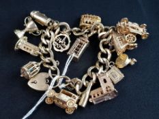 9 CARAT GOLD CHARM BRACELET WITH APPROX 15 COLLECTABLE CHARMS - CIRCA 108 GRAMS