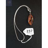 SILVER MOUNTED AMBER PENDANT ON SILVER CHAIN