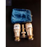 Pair of opera glasses in case