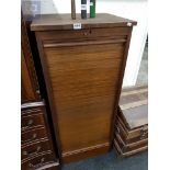 A WOODEN FILING CABINET WITH FRAMED SHUTTER DOOR