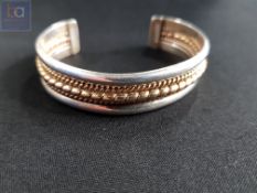 STERLING SILVER AND GOLD FRONT CUFF BANGLE