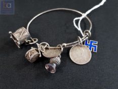 ANTIQUE SILVER CHARM BRACELET TO INCLUDE SILVER AND ENAMEL SWASTIKA