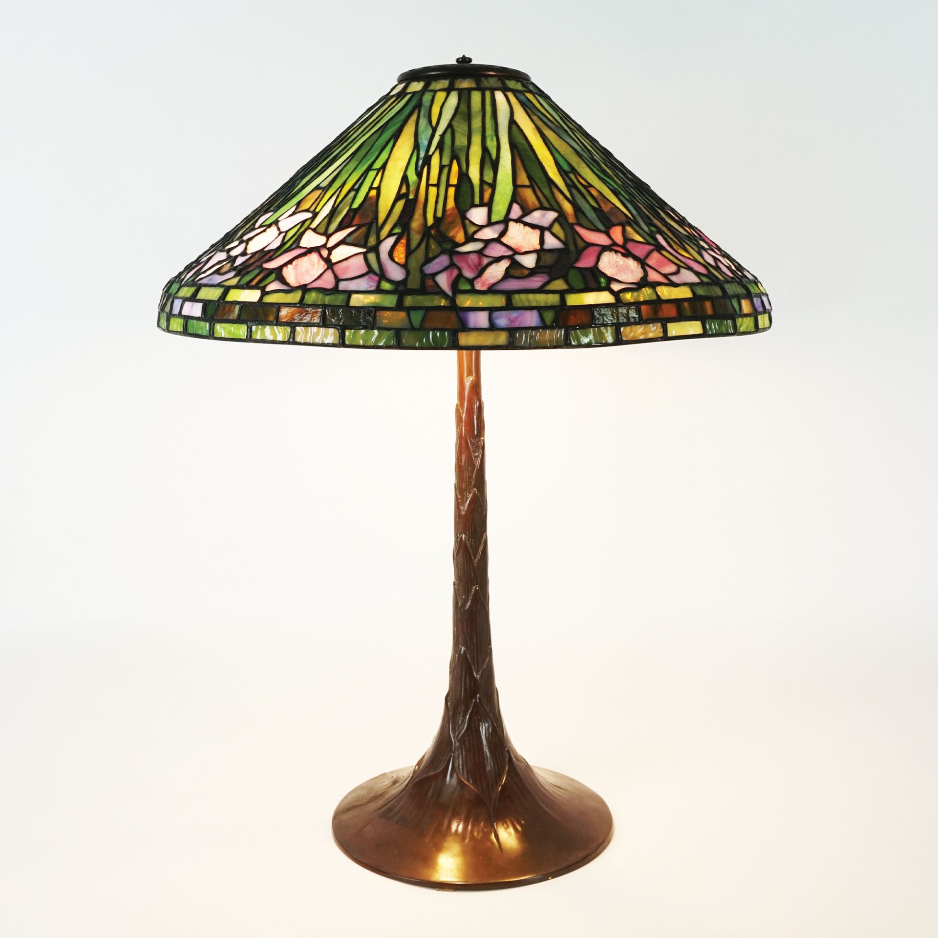 A patinated bronze and glass paste table lamp, Art Nouveau