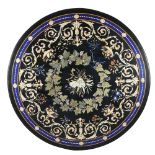 A round black top inlaid in polychrome marbles and pietre dure