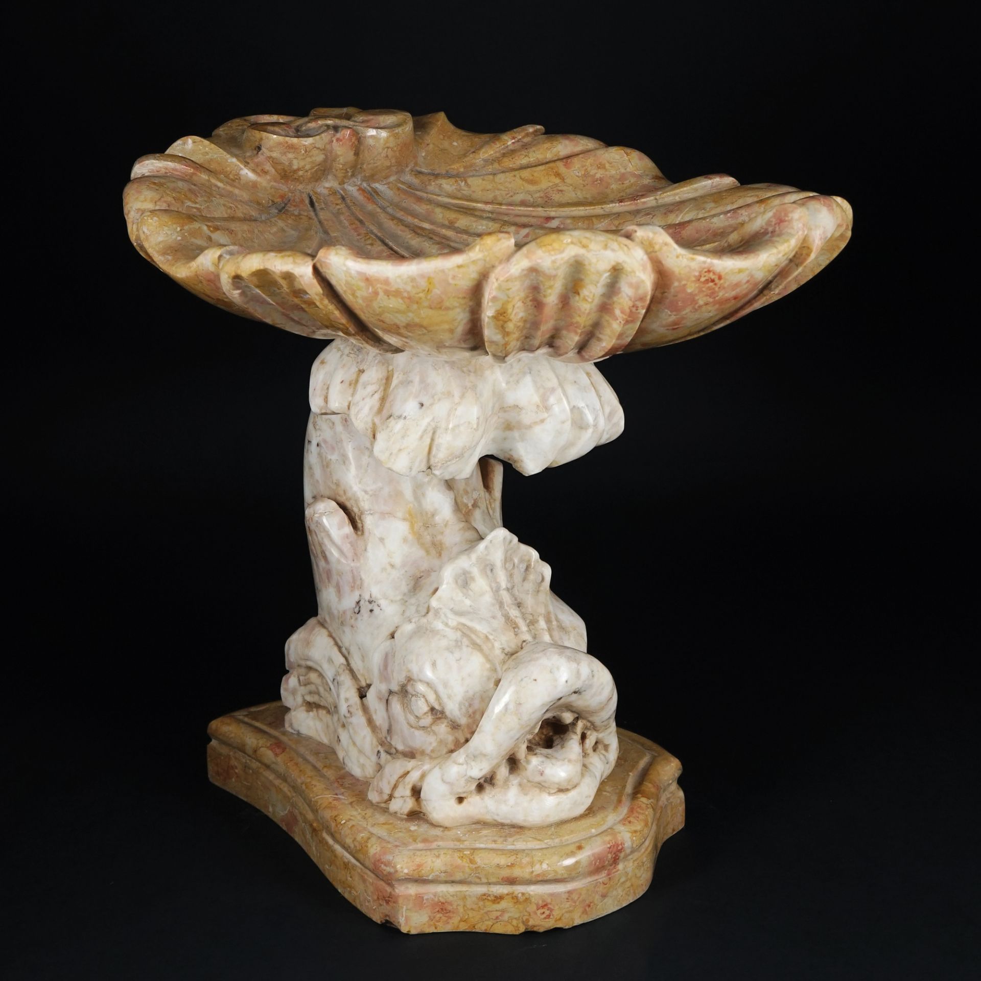 A white and yellow marble shell stand