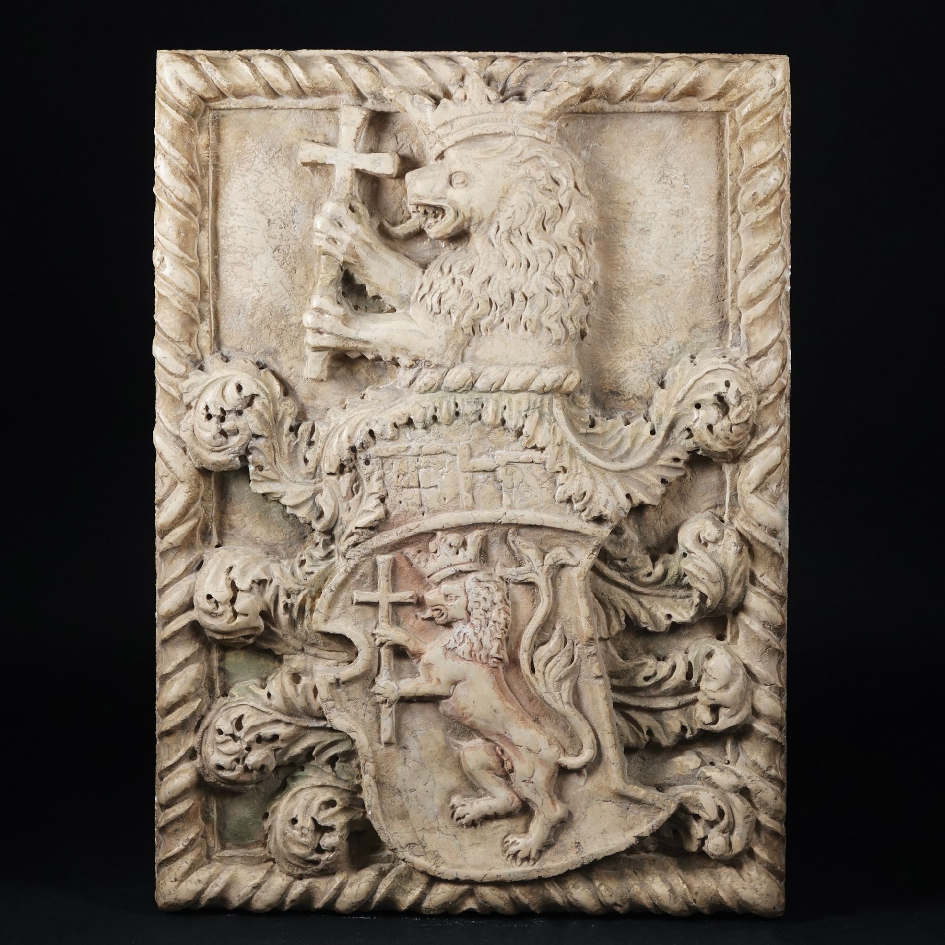 A rectangular carved marble coat of arm