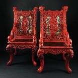 A pair of Chinese red lacquered carved wood armchairs, early 20th century