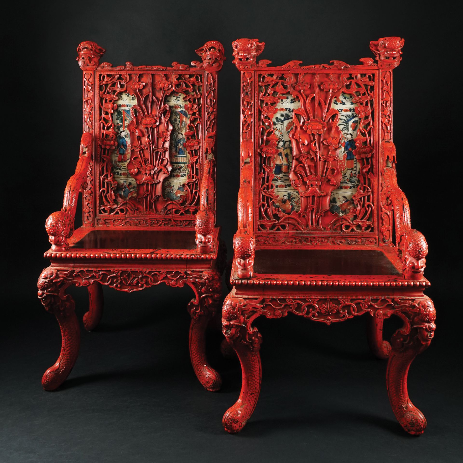A pair of Chinese red lacquered carved wood armchairs, early 20th century