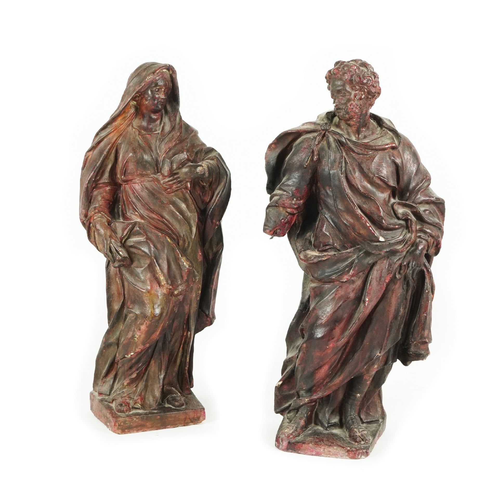 A pair of patinated plaster figures of The Virgin and Saint John, 18th century