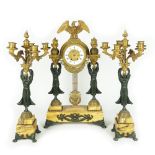 A French gilt and patinated bronze mantel clock and a pair of six-light flambeaux