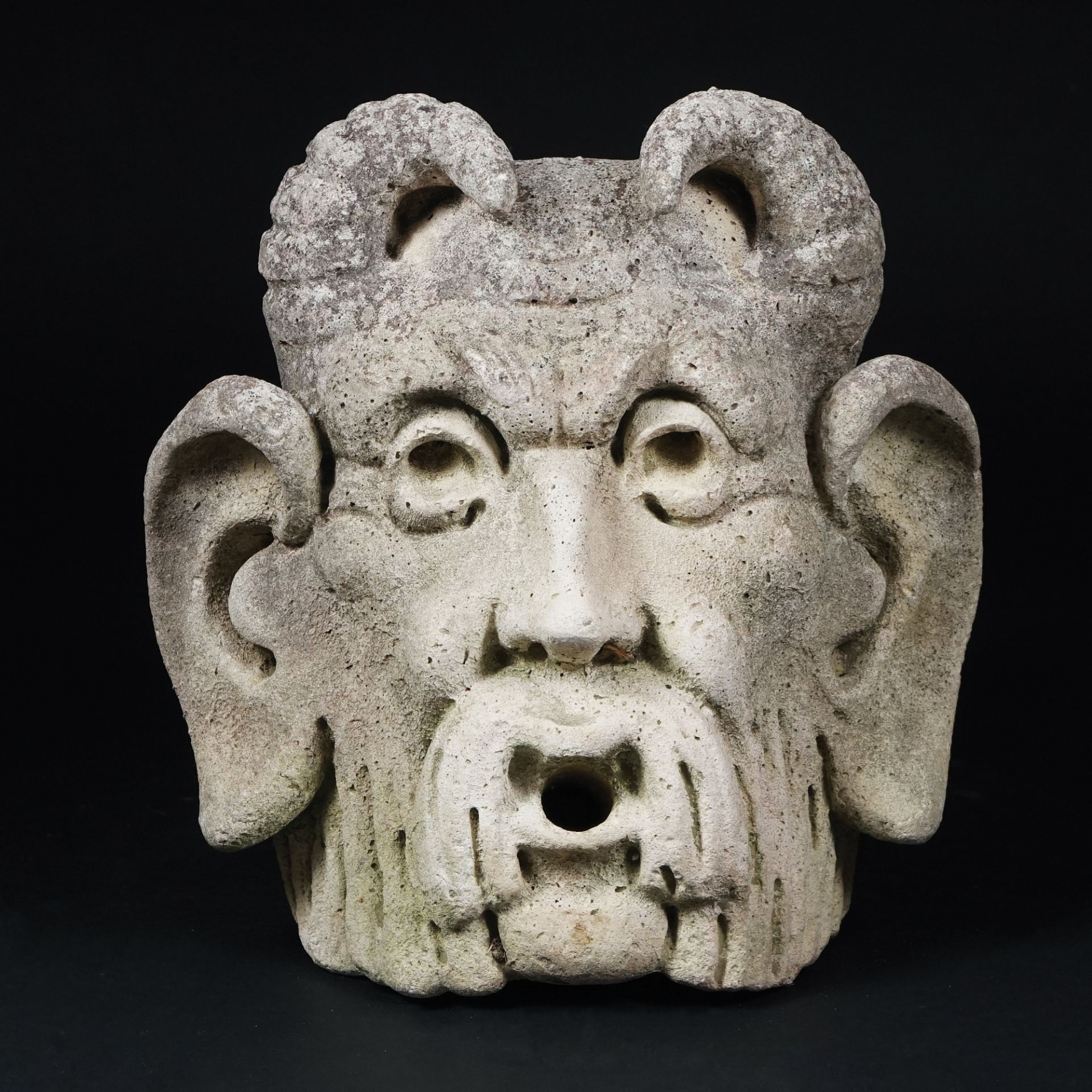 An agglomerated stone satyr's head