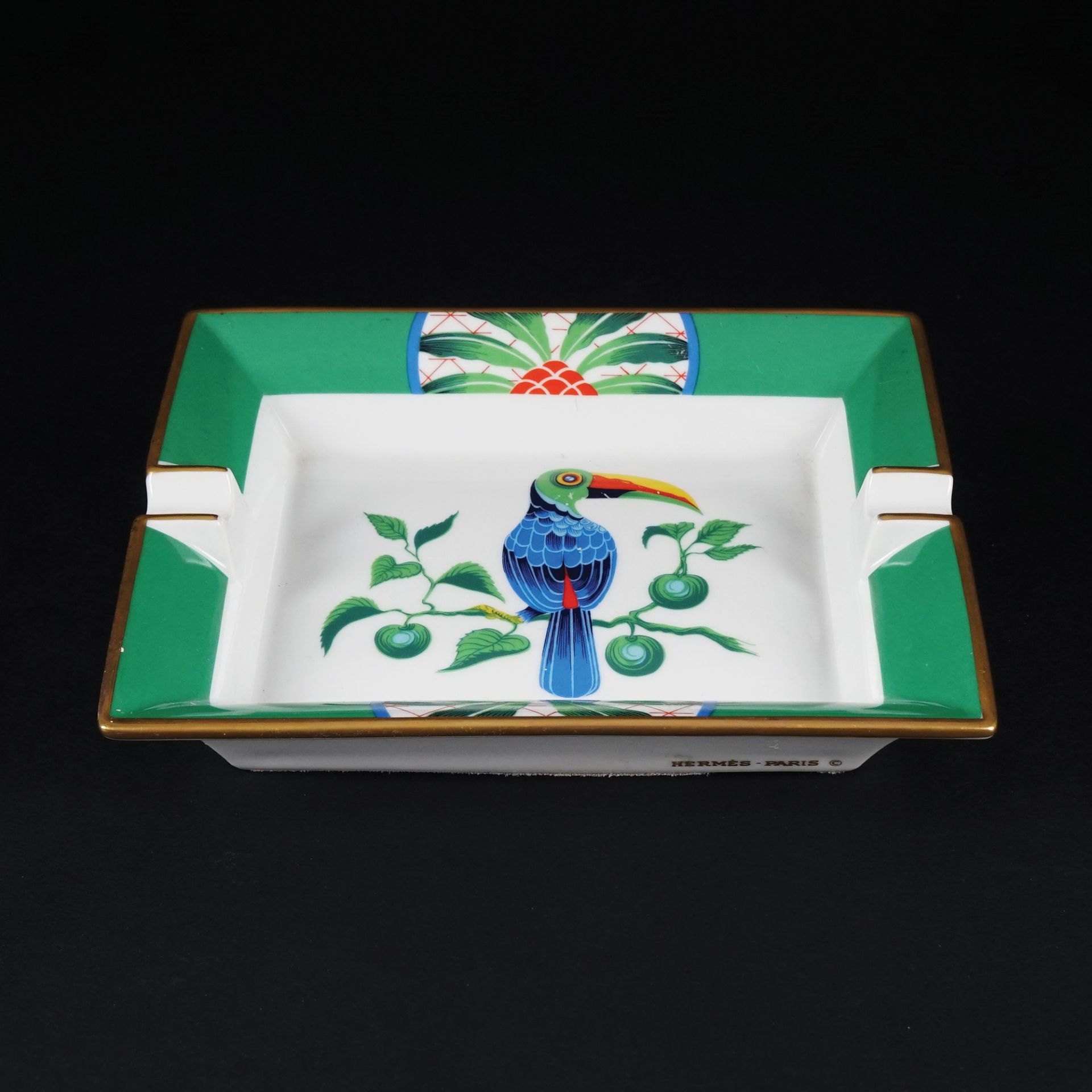 An Hermès white and polychrome Toucan ashtray