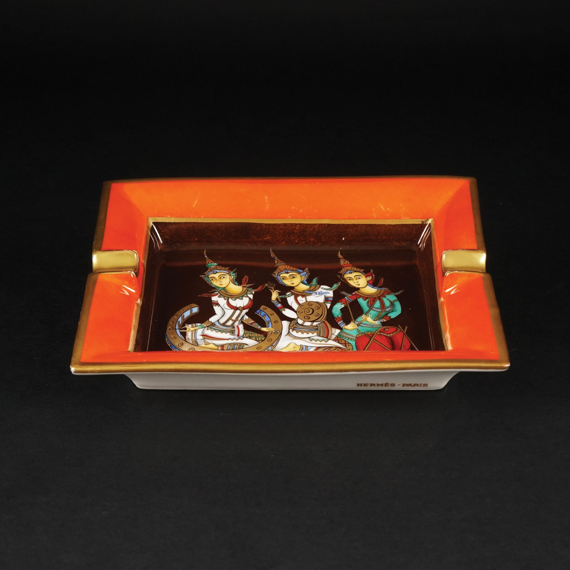 An Hermès gilt and polychrome Trois Divinités ashtray