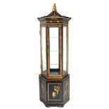 An ebonized and gilt wood center pagoda vitrine