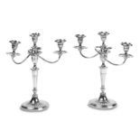 A PAIR OF GEORGE III STYLE SILVER PLATE THREE LIGHT CANDELABRA (2)