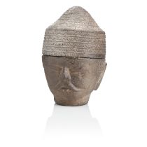 A SOUTH EAST ASIAN CARVED GREY STONE HEAD