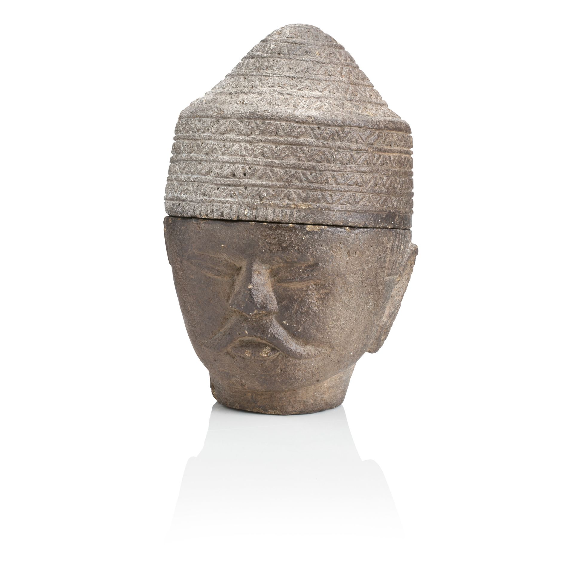 A SOUTH EAST ASIAN CARVED GREY STONE HEAD