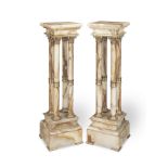 A pair of late 19th / early 20th century French gilt bronze mounted and beige onyx pedestals (2)