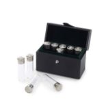 A cased set of ten novelty silver-mounted glass butt marker shot glasses resembling cartridge she...