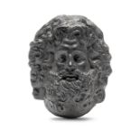 A black basalt wall mask probably 19th century