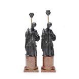 A pair of late 20th century bronzed and faux porphyry resin figural lamps after the antique, in t...