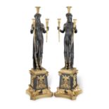 A pair of gilt and patinated bronze figural three light candelabra probably late 19th / early 20...
