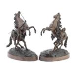 After Guillaume Coustou (French, 1677-1746): A pair of late 19th century patinated bronze models ...