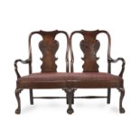 A carved mahogany double chairback settee incorporating or constructed from some mid-18th century...
