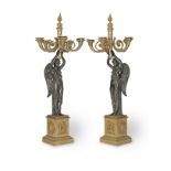 A pair of late 19th / early 20th century French patinated and gilt bronze figural six light figur...