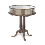 A late Victorian mahogany and brass mounted bijouterie table in the George III style by repute or...